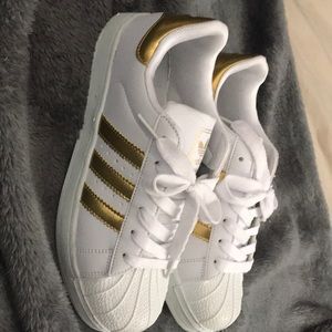 White and gold adidas shoes